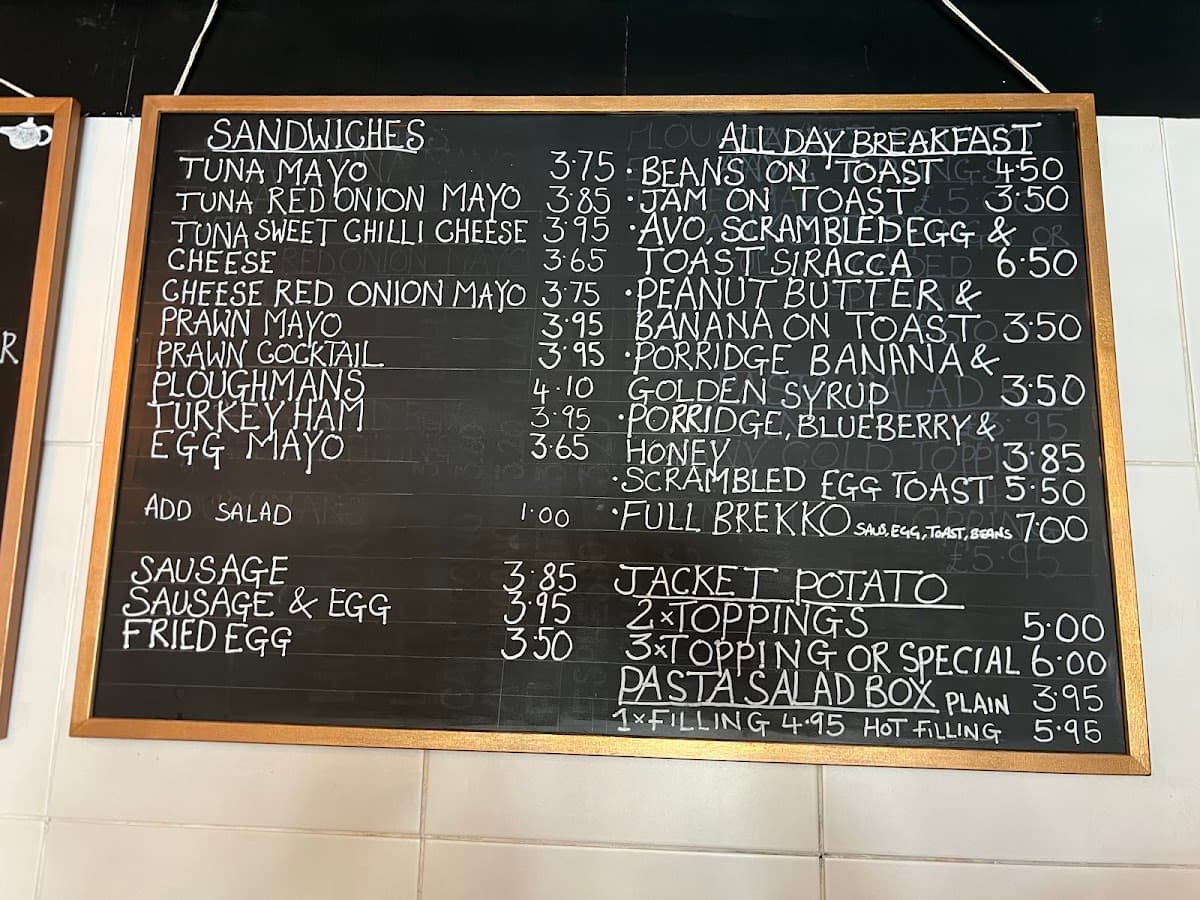 Before: Enclave's handwritten chalkboard menu of sandwiches, all day breakfast and jacket potatoes, in a gold frame on a tiled wall