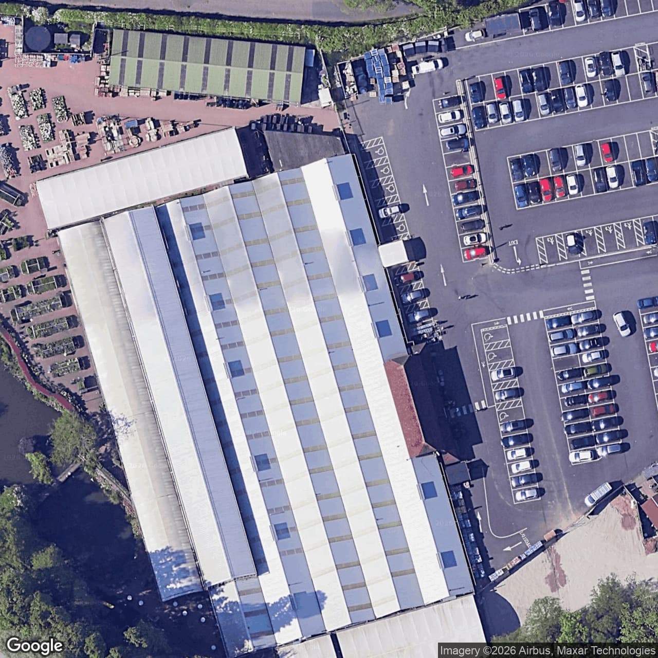 A satellite view of a garden centre whose long roof is mostly glass